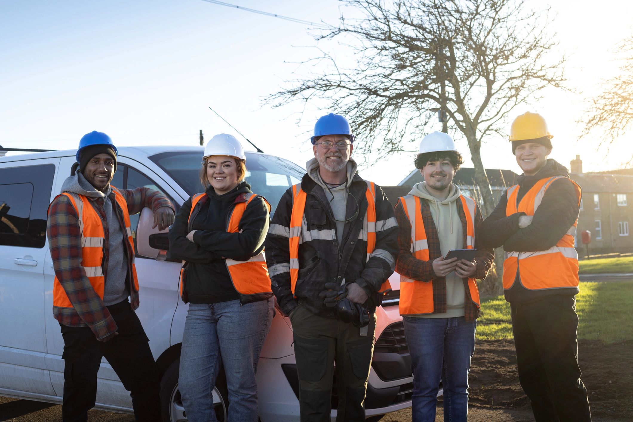 Handyman crew standing together near a service van
